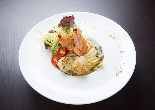 gourmet dish with shaved truffles on pasta in dark fine dining setting with gold accents